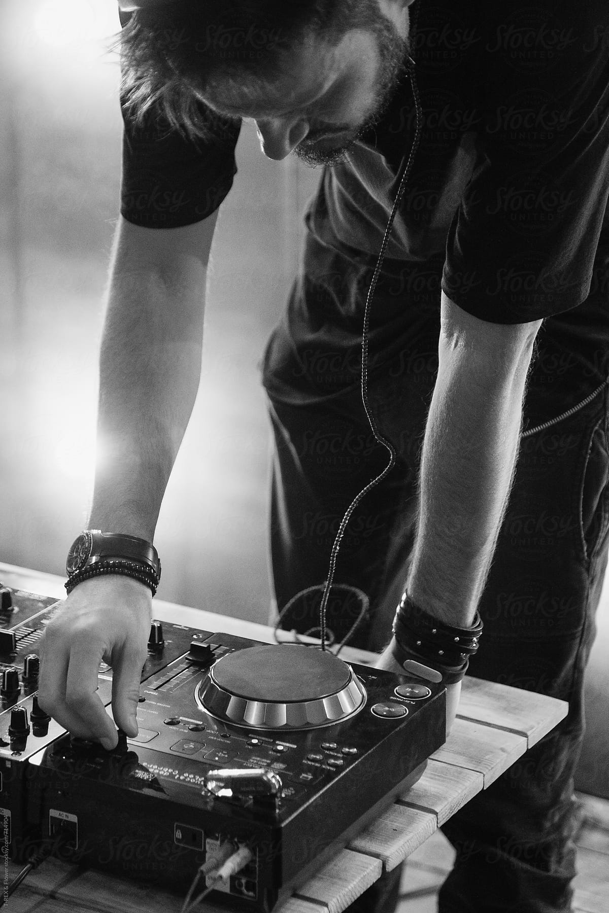 Black and white photo of dj playing in the club