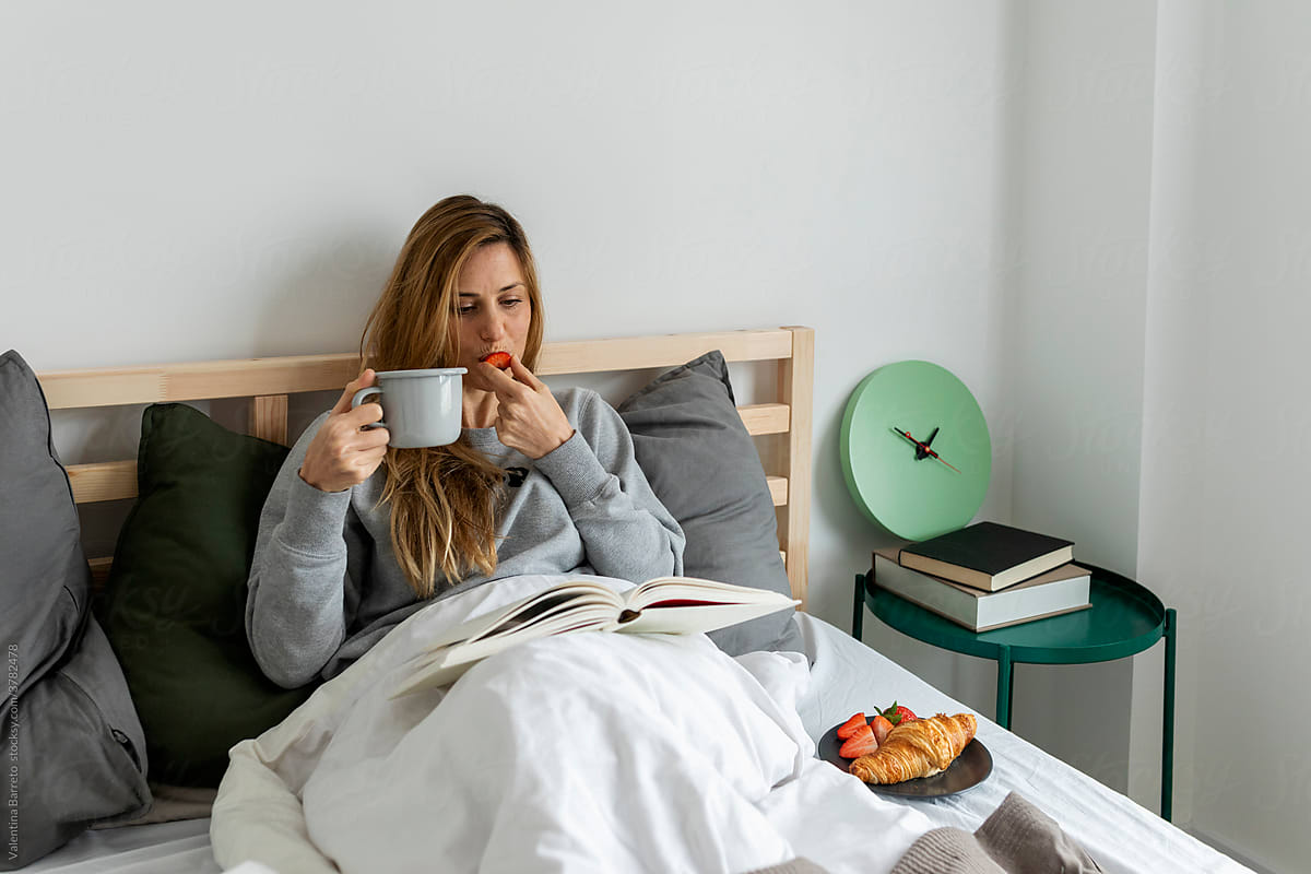 Caucasian Woman having breakfast In Bed