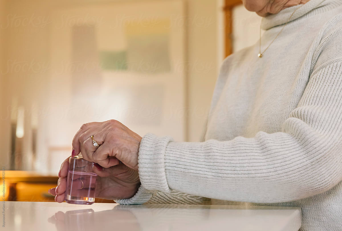 Senior Citizen Putting Applying Hand Sanitizer