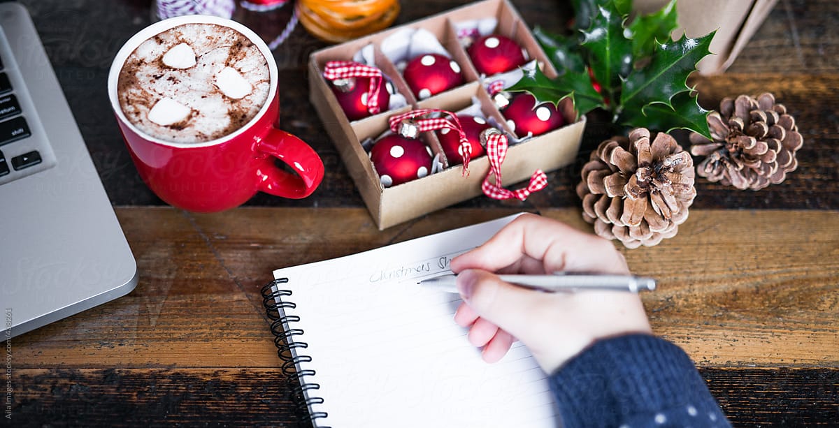 Writing a Christmas shopping list at a desk