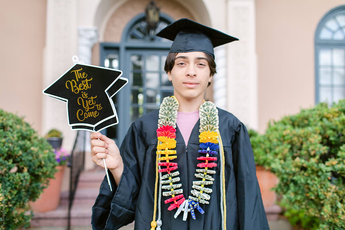 Teen boy with banner on his graduation day