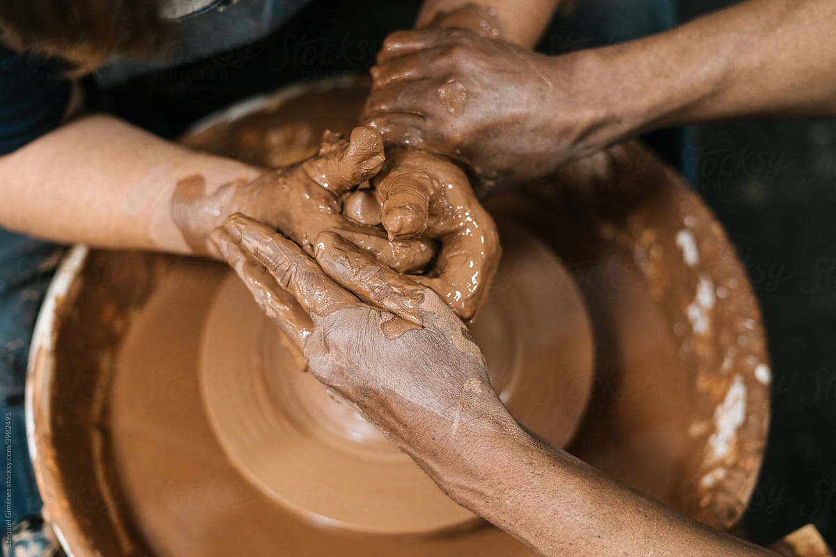 Anonymous hands of potters at the potter\'s wheel