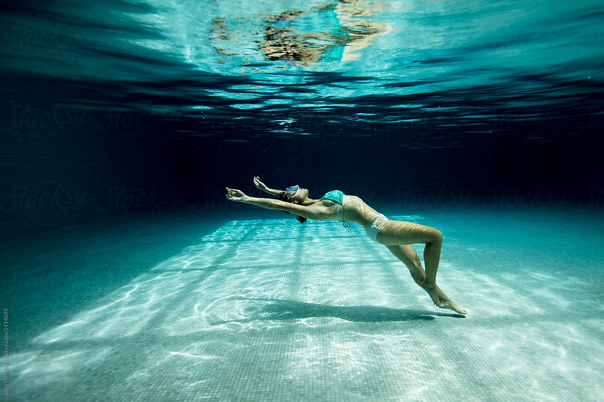 Underwater woman portrait with bikini in swimming pool