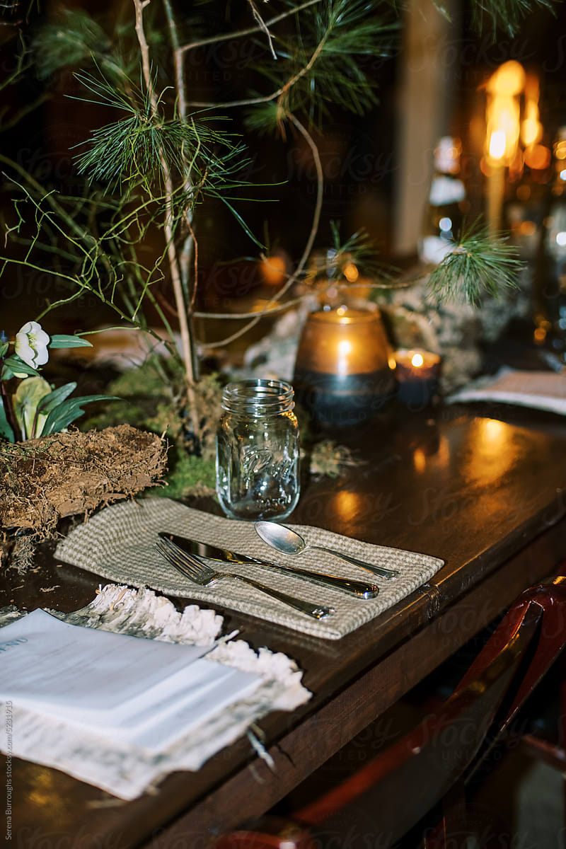 Decorated table with floral arrangements at an indoor dinner party