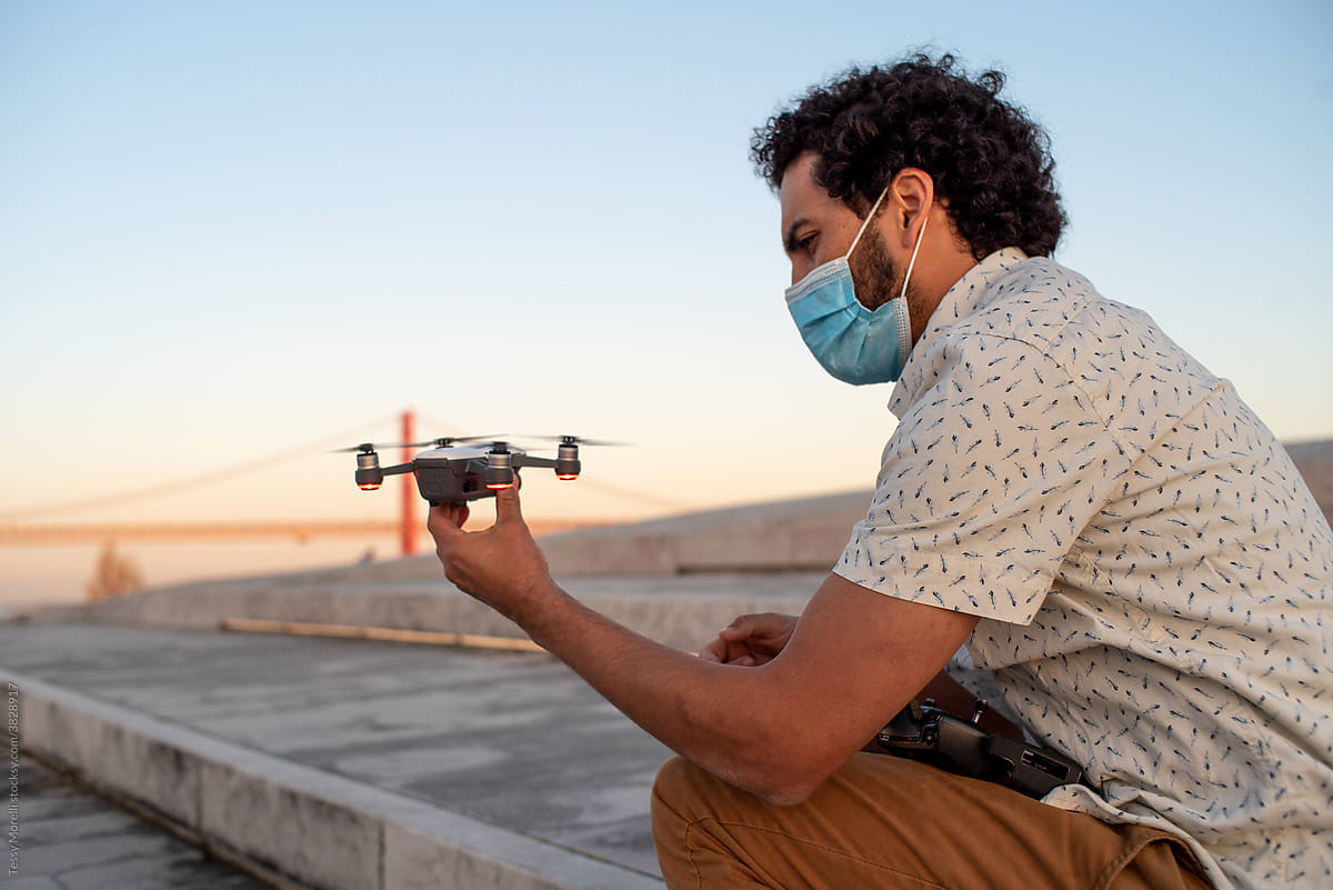 Filmmaker holding a drone device and remote control