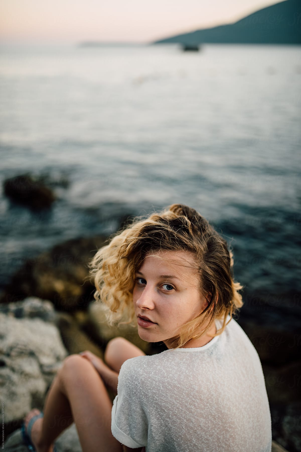 Young Beautiful Woman Sitting Near The Sea By Stocksy Contributor Boris Jovanovic Stocksy 