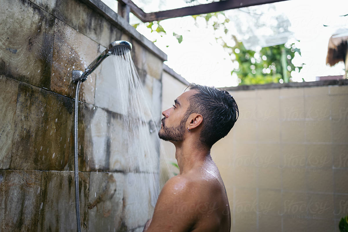 Man showering in an open bathroom in Asia