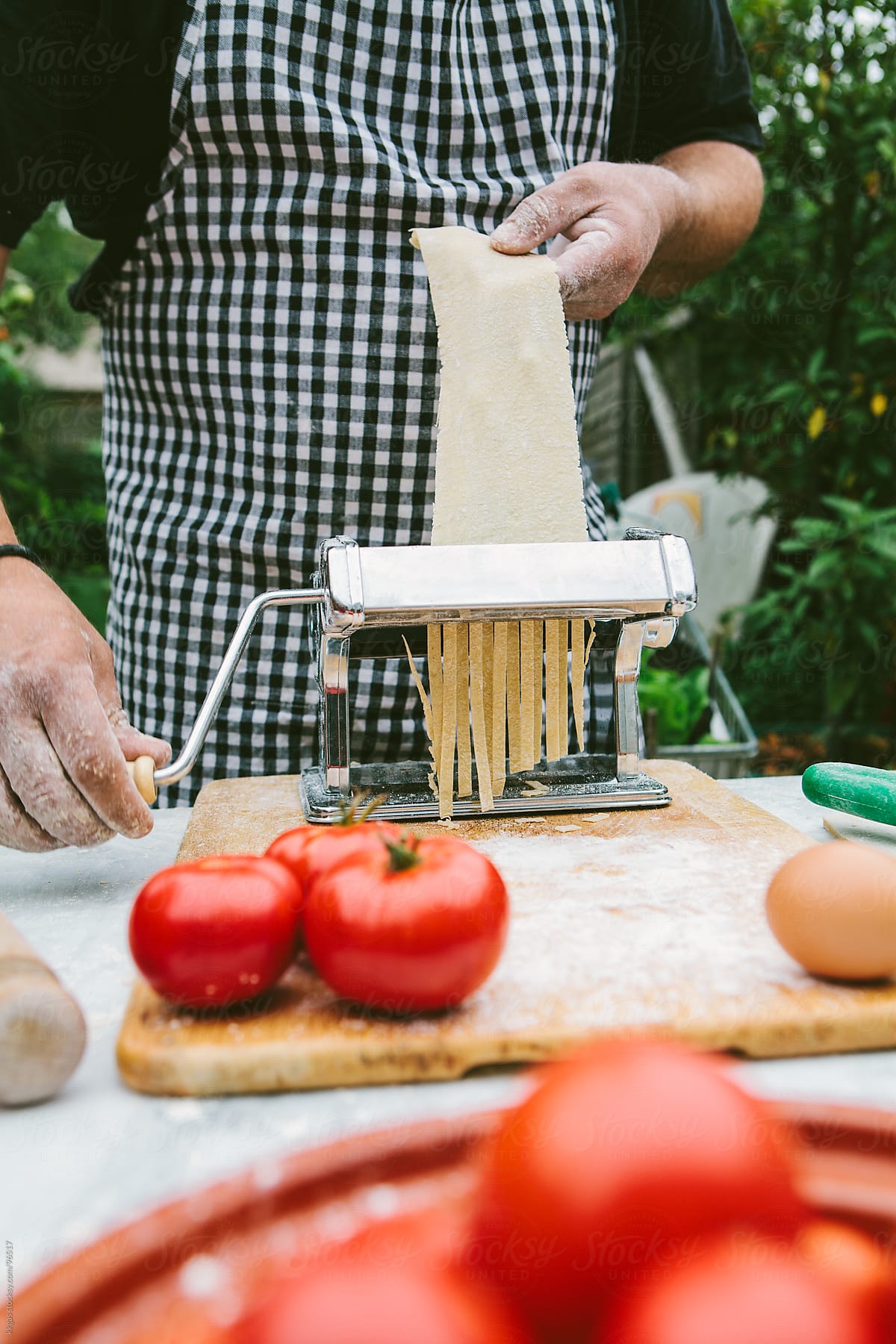 Man making fresh pasta with organic ingredients.