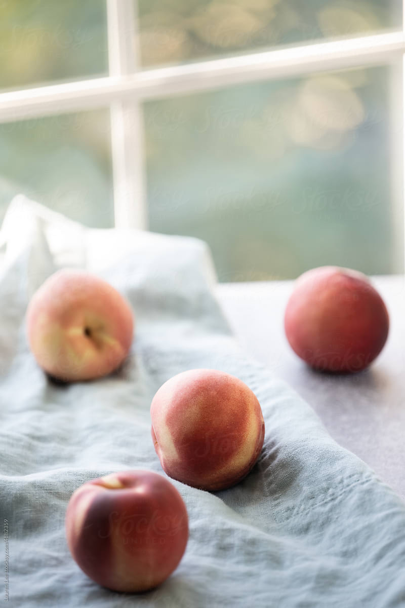Fresh white peaches by the window