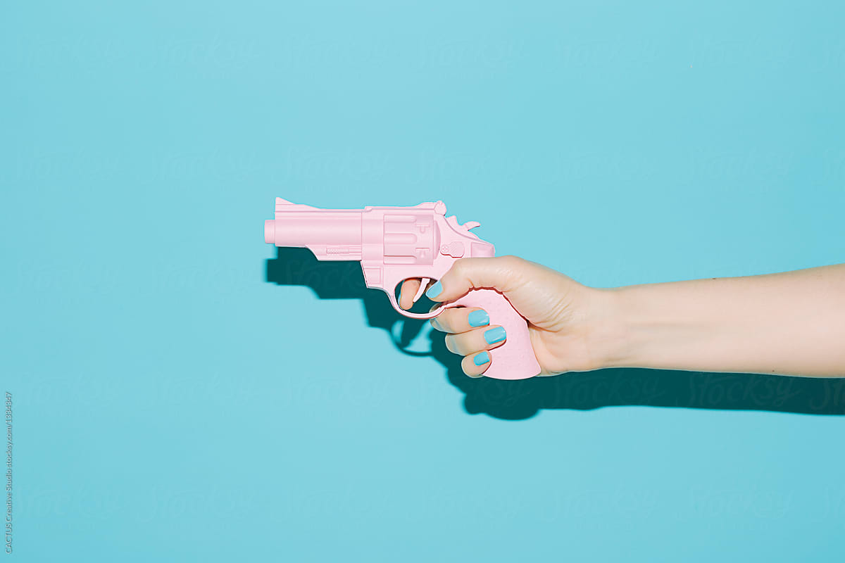 Hand holding a pink gun