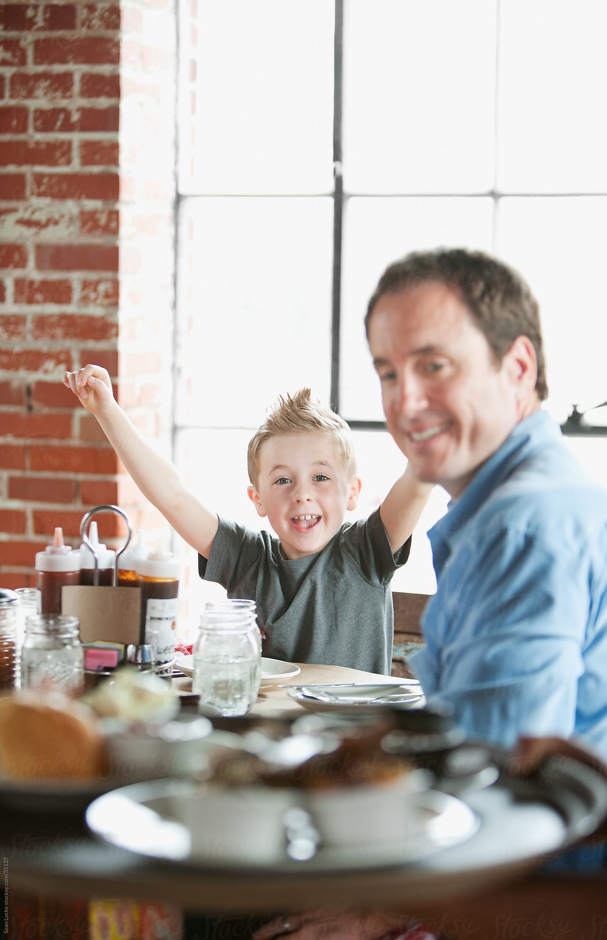 Barbeque: Child Cheers as Server Brings Food