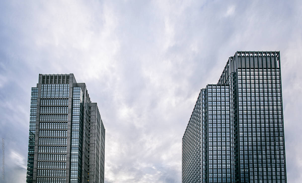 Modern buildings against cloudy sky in city