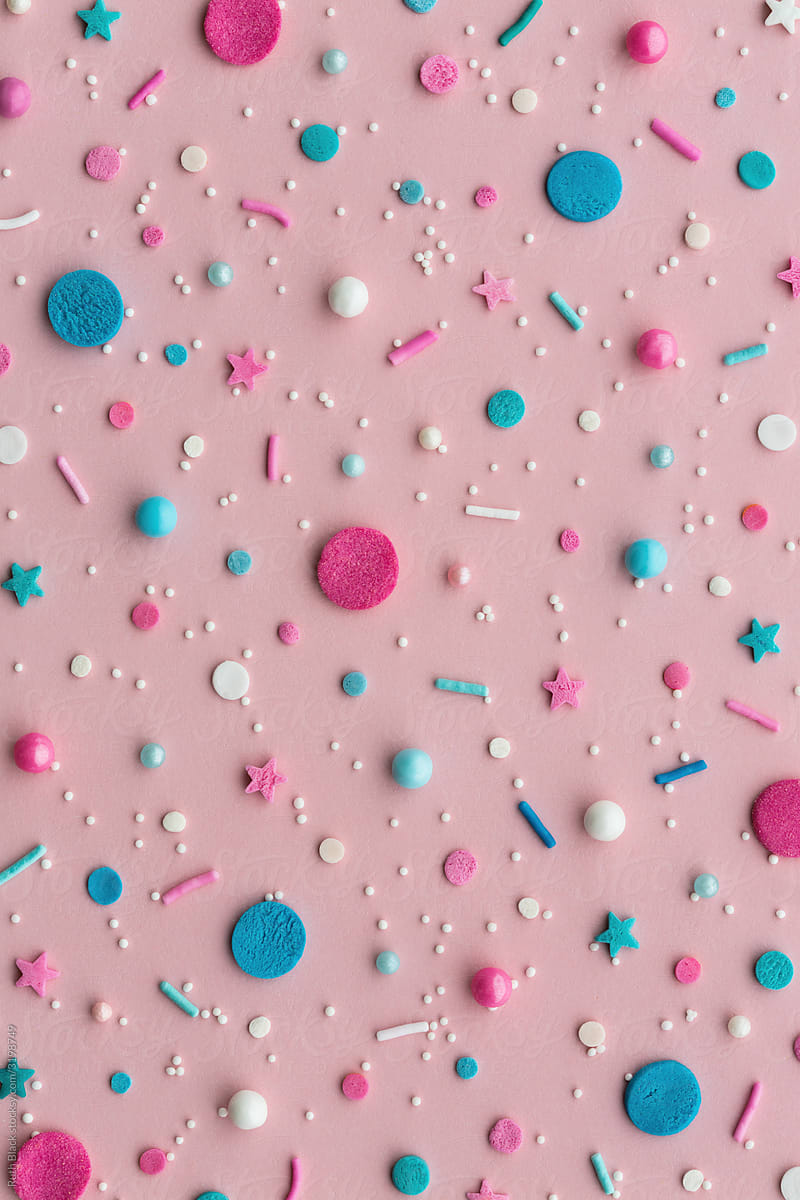 Sugar sprinkles on a pink background