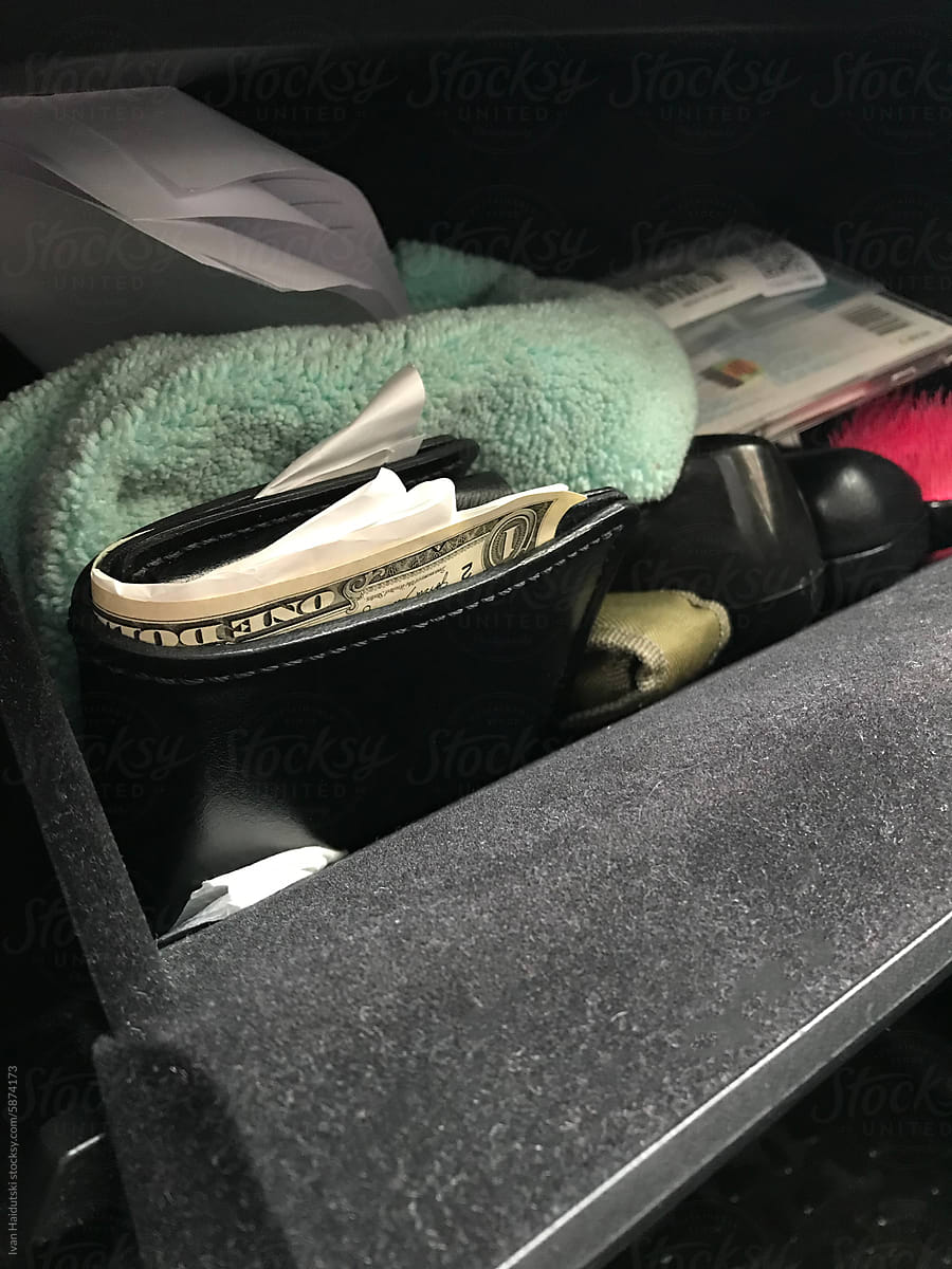 Wallet with money US Dollars and receipt inside car - UGC