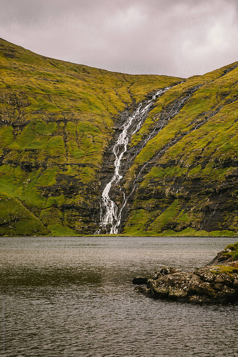Water cascade falling into the sea in Faroe Islands