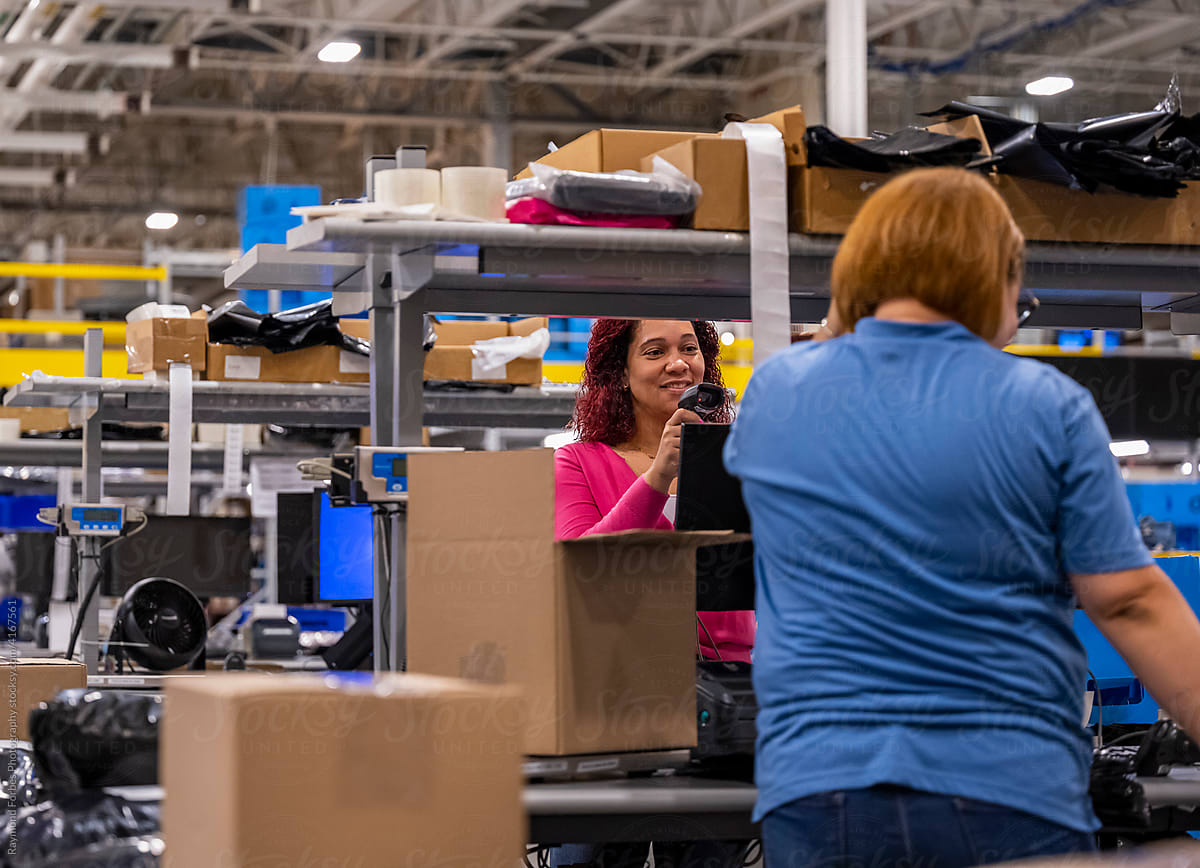Two workers together at open warehouse for E-Commerce