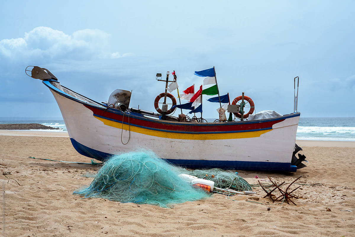 Fishing boat on the beach on winter windy day