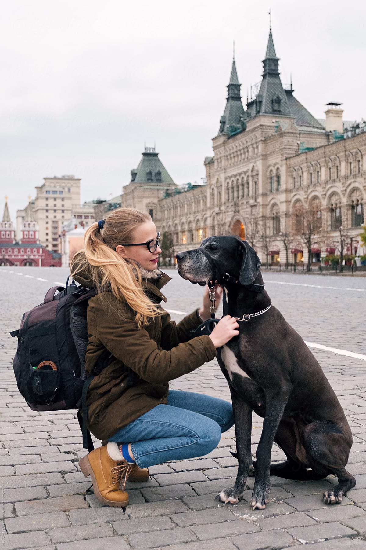 Portrait of traveler playing with her dog