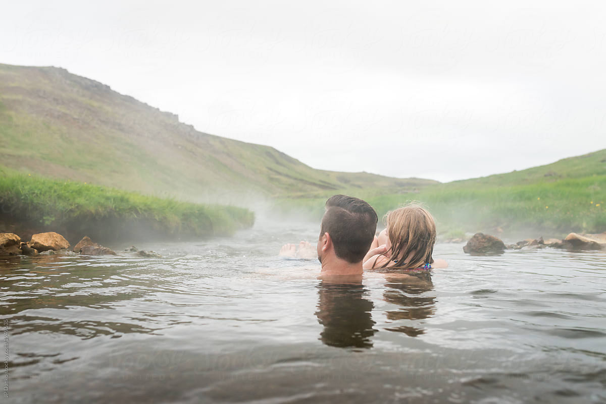 Dad and daughter enjoy moment together swimming in Iceland volcanic hot river