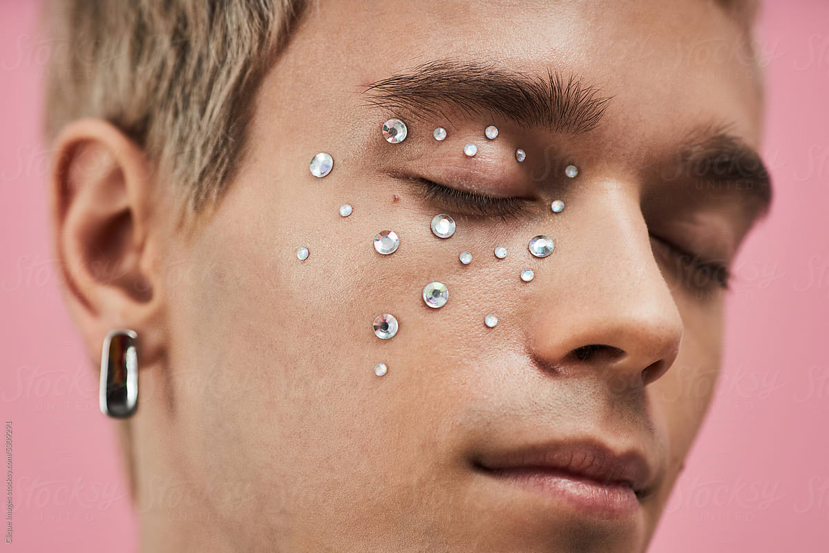Young Man With Rhinestones On Face by Stocksy Contributor Clique