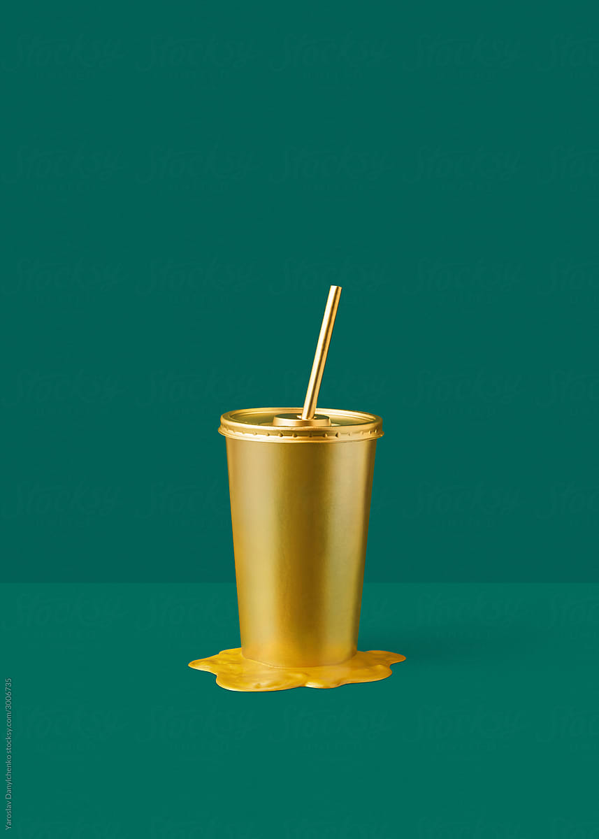 Painted cup in a golden puddle.