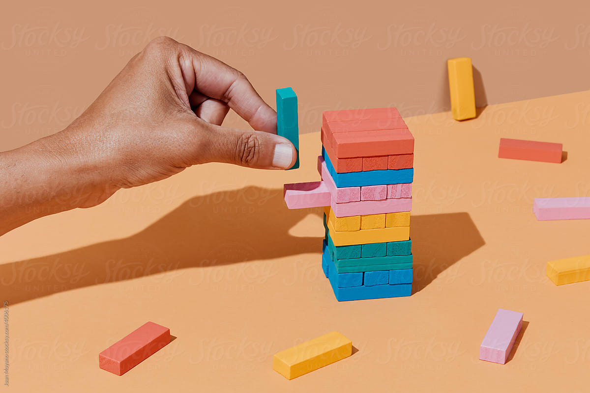 man playing with toy blocks