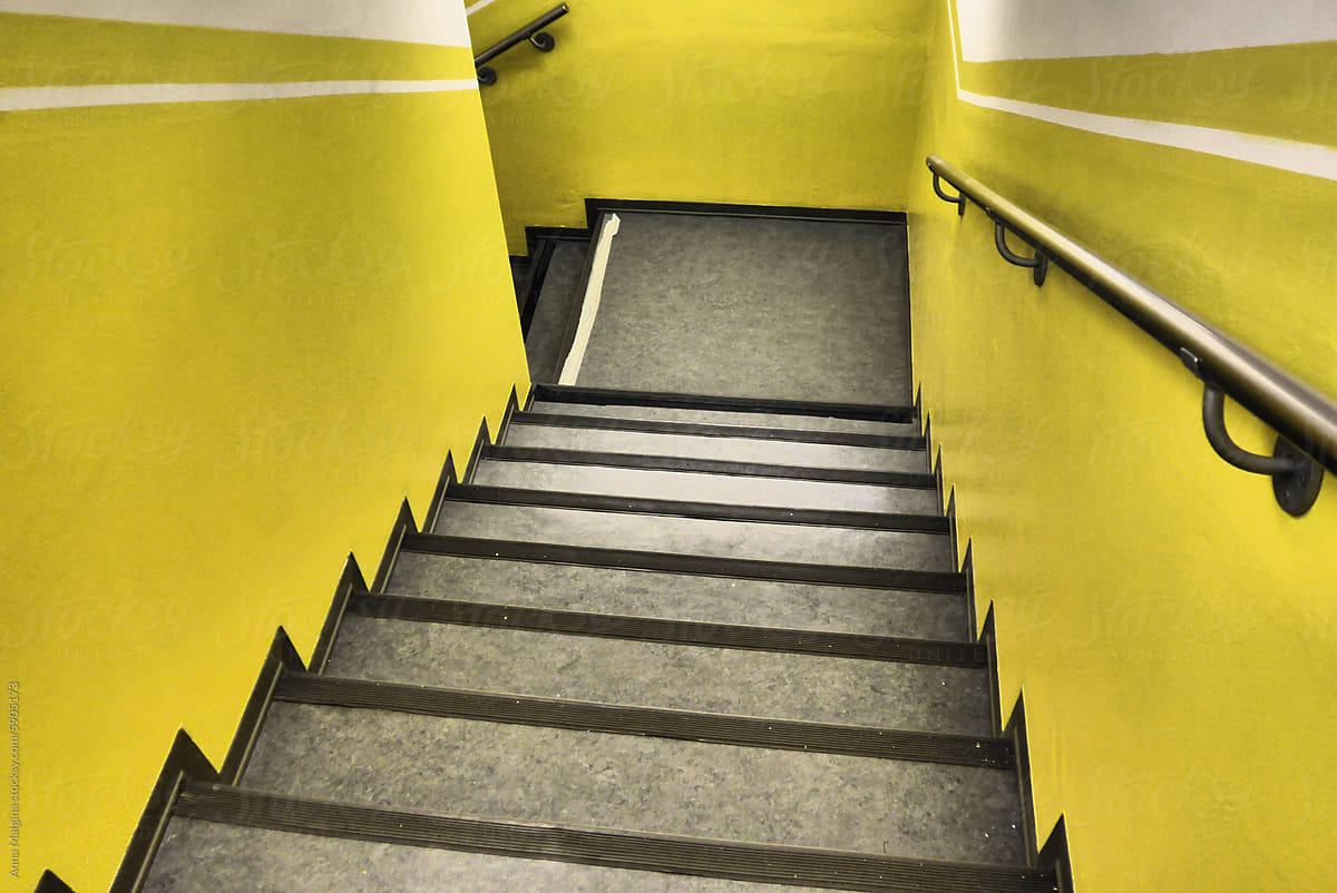 Bright Yellow Stairwell With Black Steps