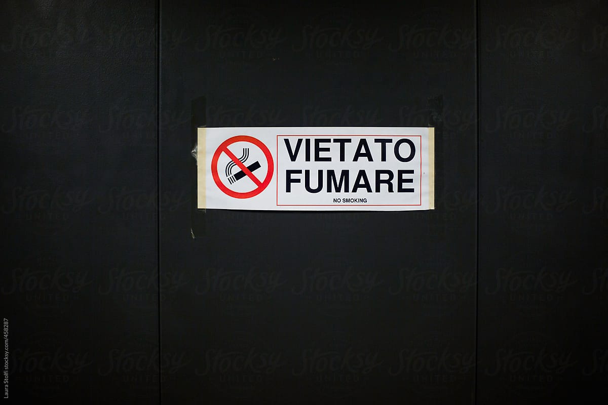 No smoking sign and write home printed on elevator metal wall
