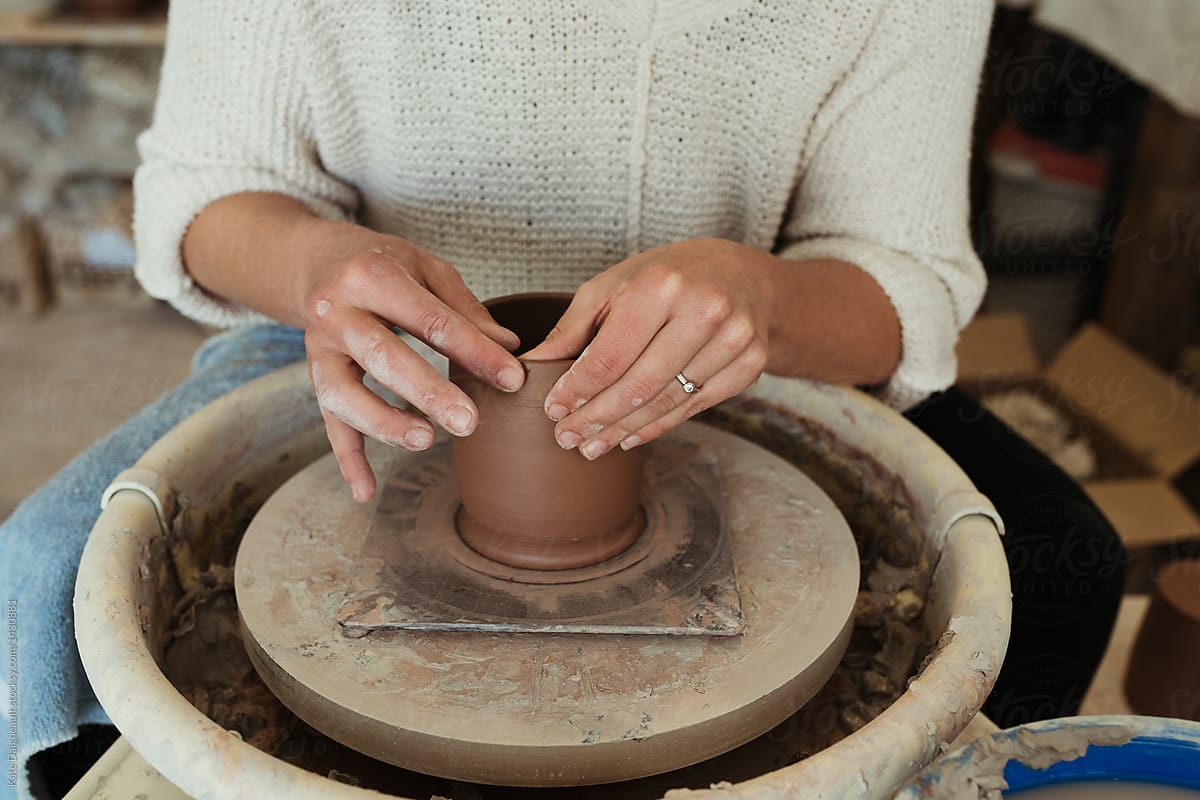 Young female potter working in her  studio