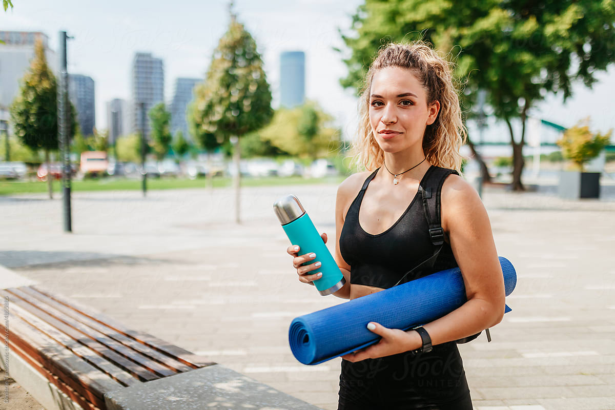 Woman With Bottle And Yoga Pad.