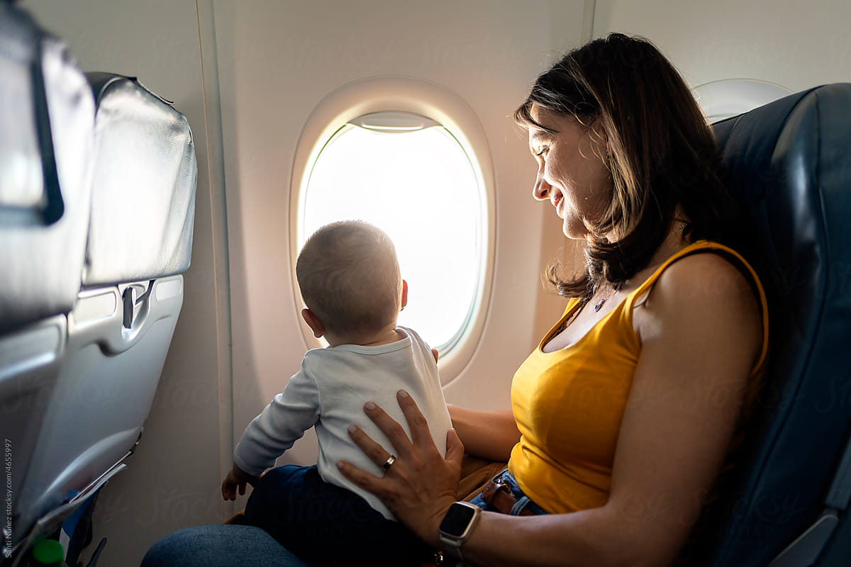 Mom Holds Son On Airplane