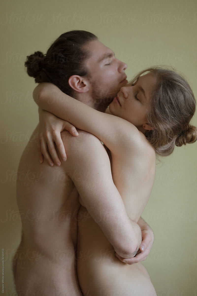 the naked piece is hugging on a neutral background. the girl and the guy have a long haircut