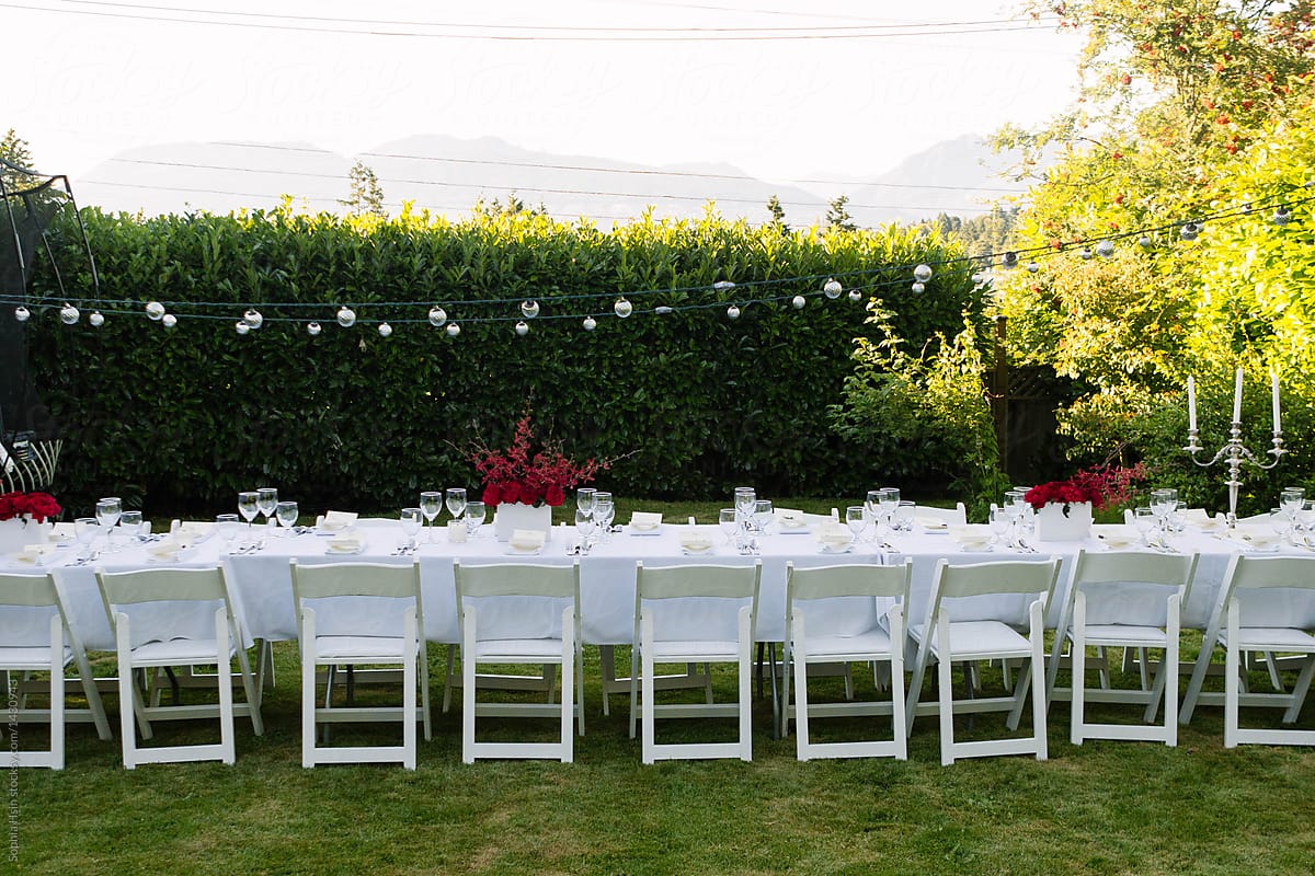 Fancy set up of white themed outdoor dinner party