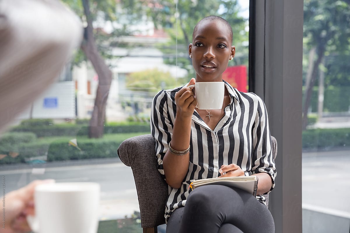 Woman drinking coffee at the business meeting