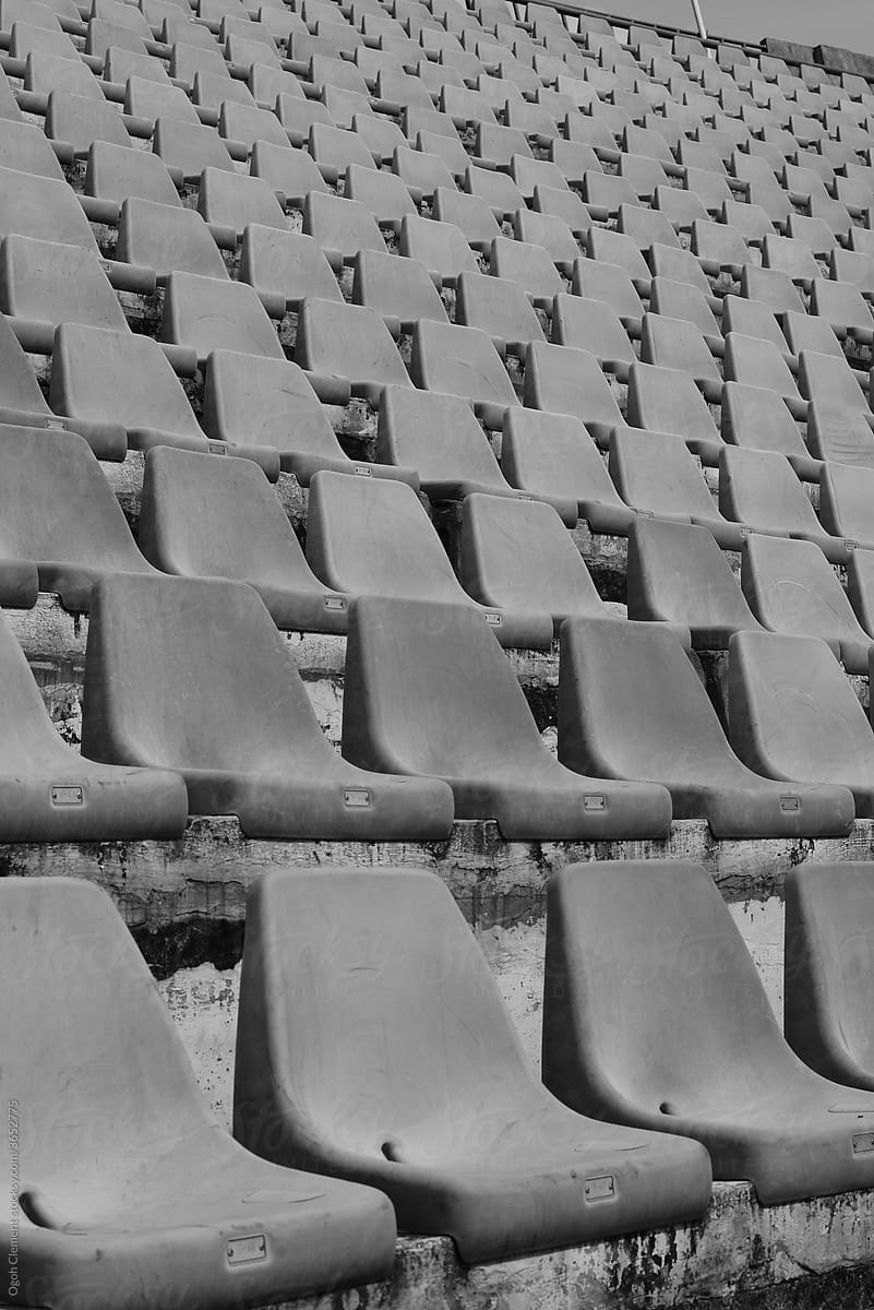 Empty old plastic chairs in a stadium