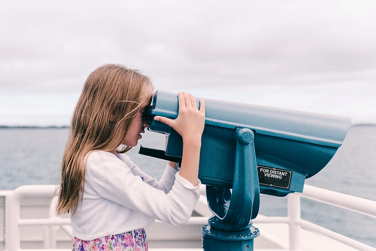 girl using a viewfinder telescope on a ferry trip