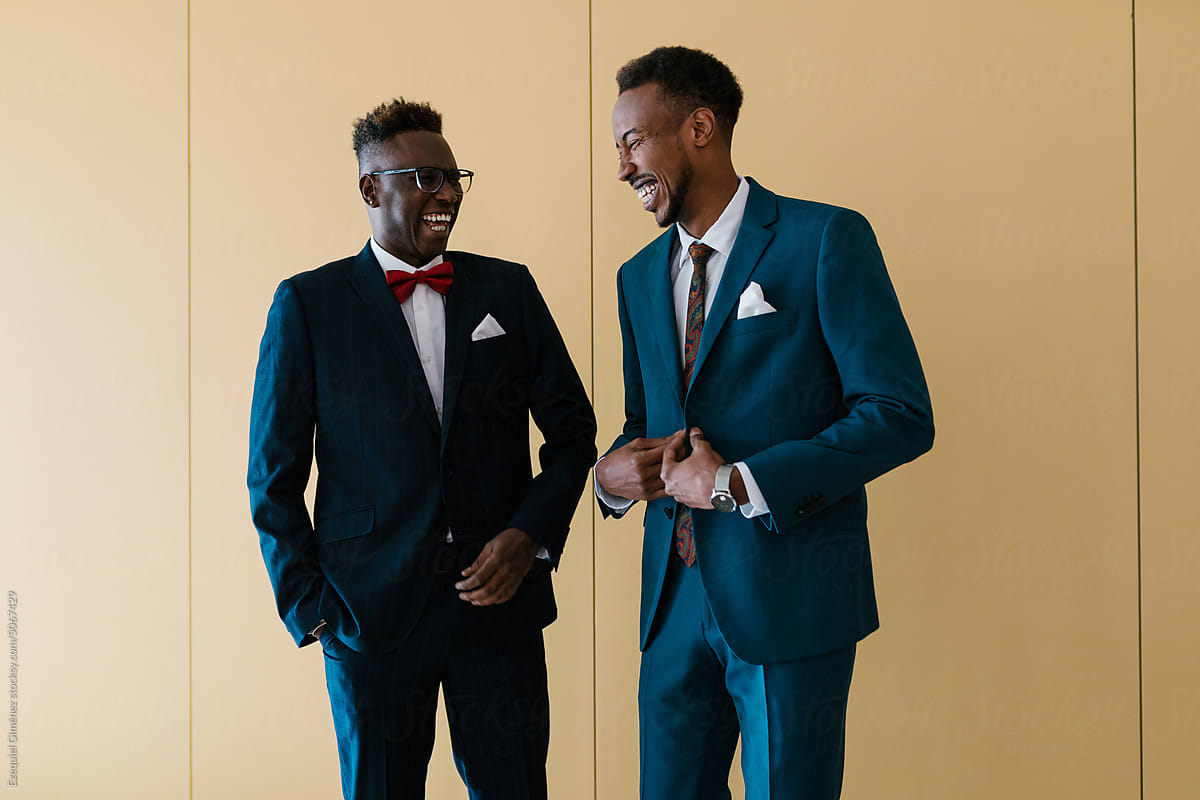 Cheerful African American men in suits