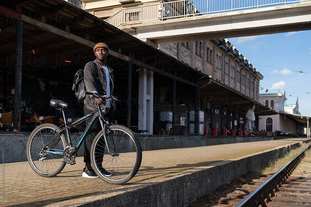 Man With Bicycle At Train Station