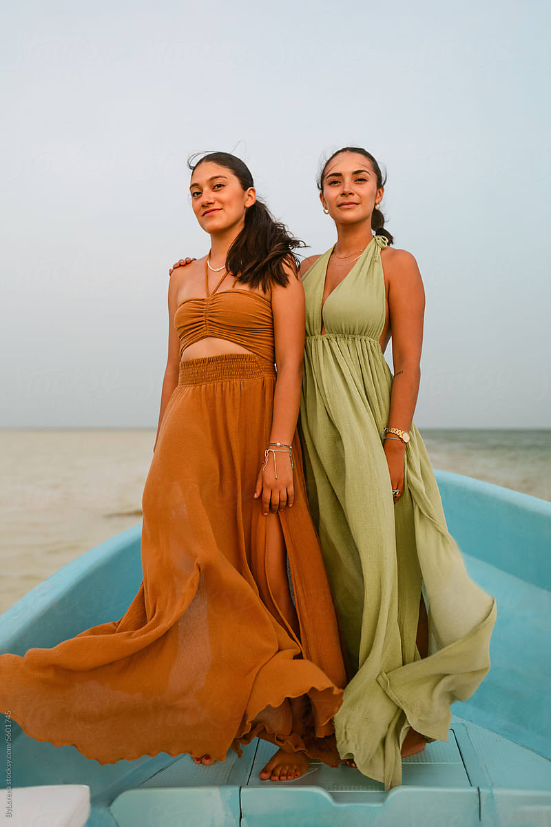 Latin Women in Flowing Dresses on Windy Boat