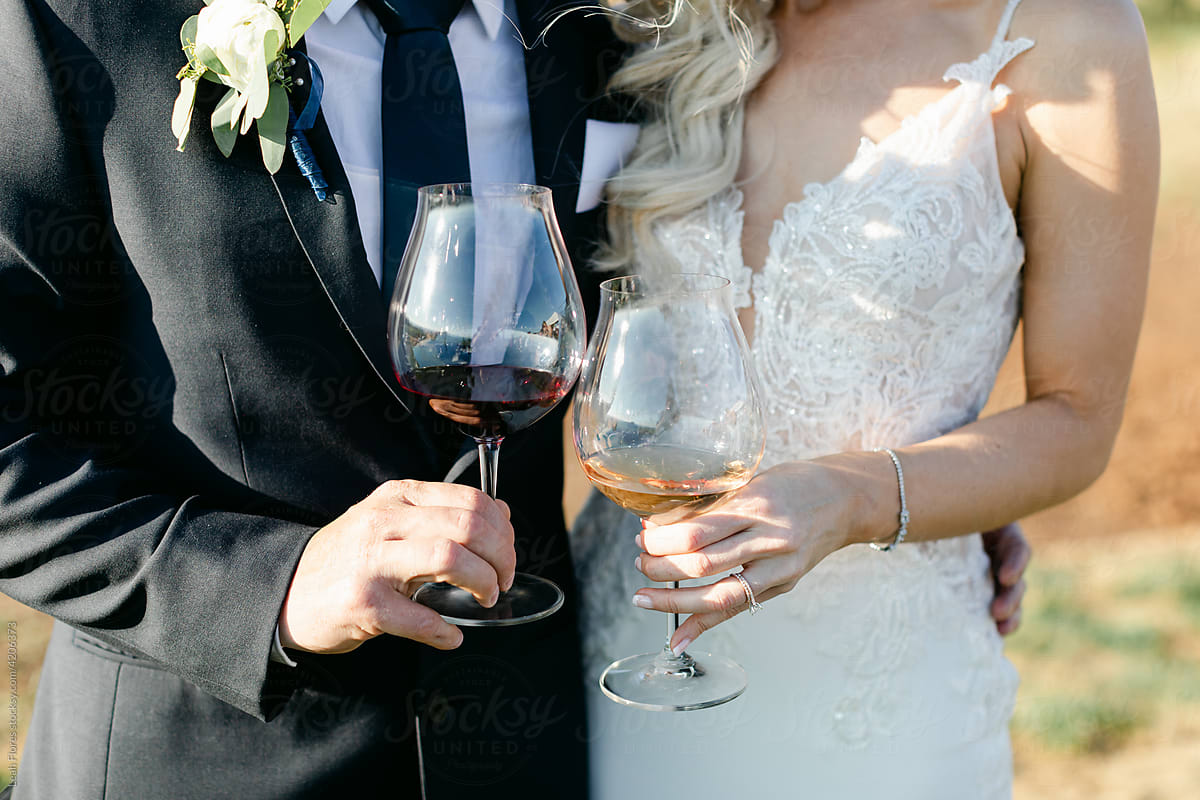 Closeup of Bride and Groom Holding Wine Glasses