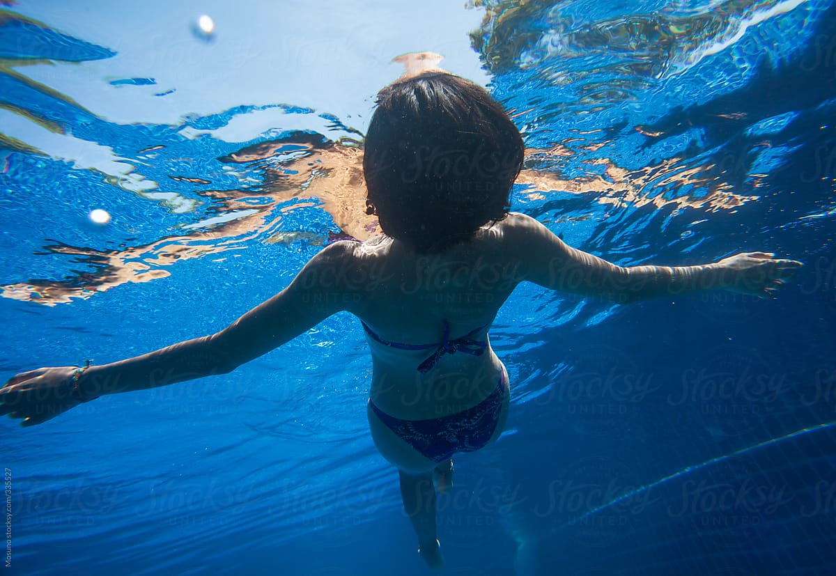 Underwater View Of A Woman Floating On Water By Mosuno Stocksy United 0820