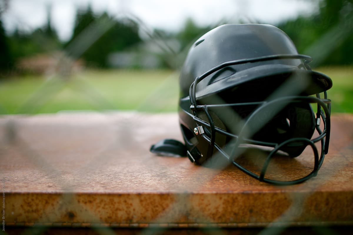 Softball helmet sits behind fence