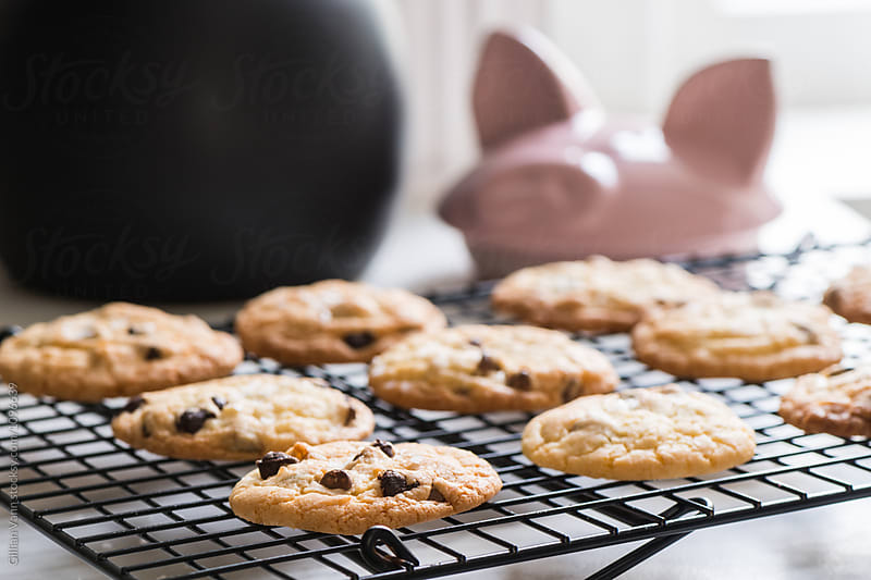 freshly baked chocolate chip cookies on a cooling rack with a co