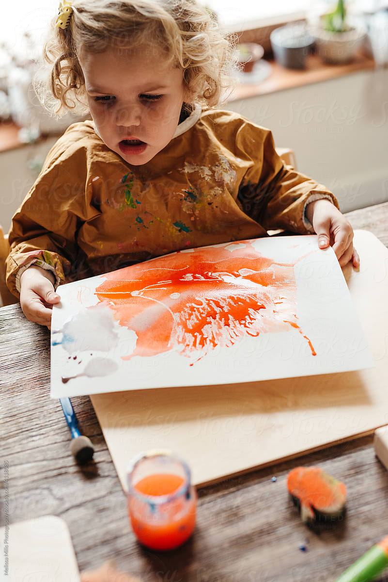 Toddler child doing blow  painting