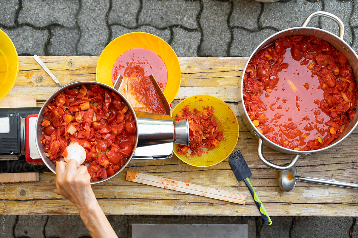 Machine making handmade Italian tomato sauce passata