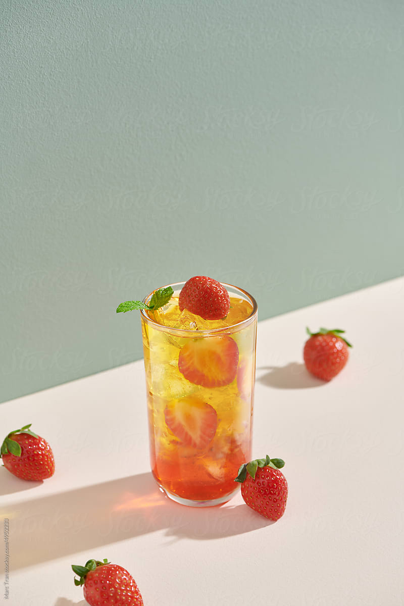 Lemonade with strawberry, mint and ice on a table.