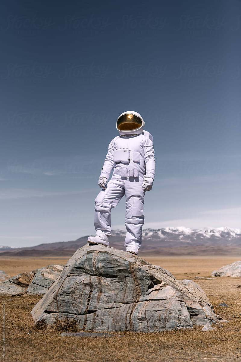 Astronaut standing on rock