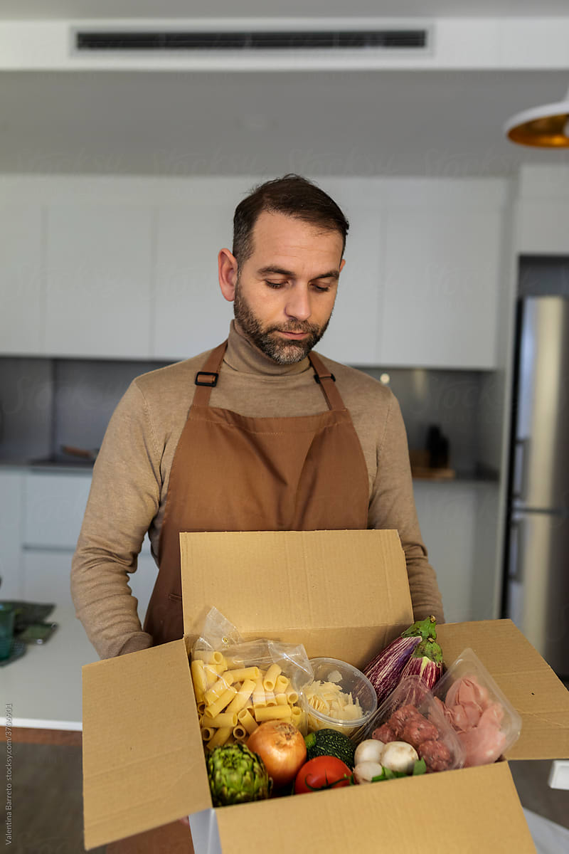 men opening a delivery box meal kit
