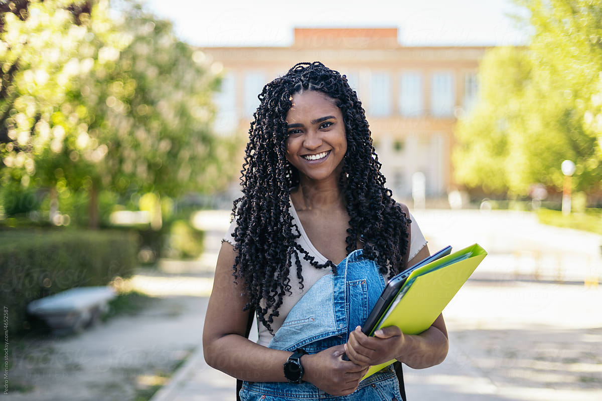 Cheerful black woman in university campus