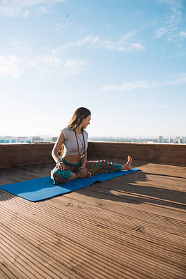 Slim Woman Practicing Yoga On Mat by Stocksy Contributor Milles Studio